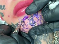 Australian bombshell Amber Luke gets a new chin tattoo