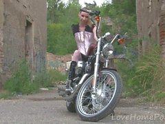 Cute teen is amazed by a big bike