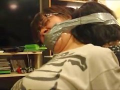 Two girls wrap gagged and bound together