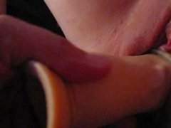 Dildo with sleeve slides into a pussy