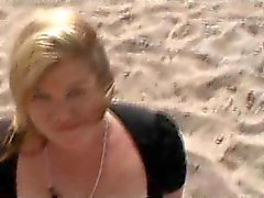 Babe sucking cock on a windy beach